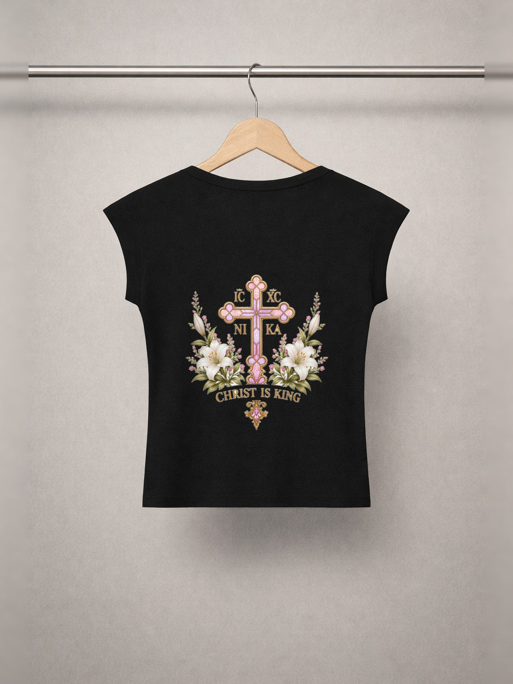 Daughter of Christ Baby Tee — Onyx Black — back print, studio hanger
