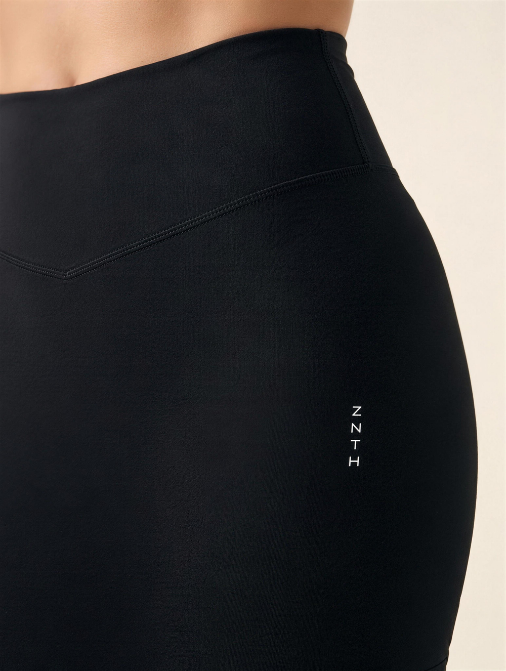 MERIDIAN Mid Rise Shorts in Onyx Black, close detail of the waistband seam and hip with the ZNTH logo